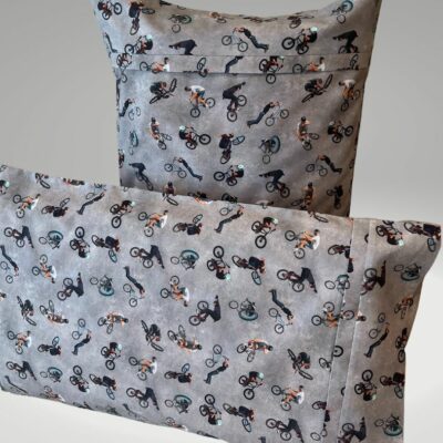 A printed cotton pillow slip with BMX riders placed in different angles